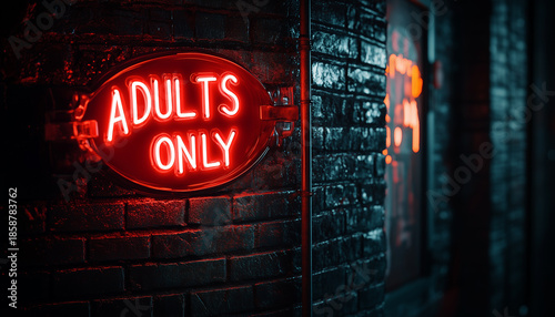 Red neon sign with text adults only glows brightly on brick wall at night. Illuminated nightlife sign signals club or bar entry