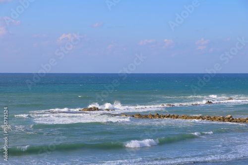 Sea waves crashing on the rocky shore of the Mediterranean Sea in Israel