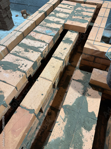 Brickwork of a heating stove bench. Smoke channels and ceiling are visible.