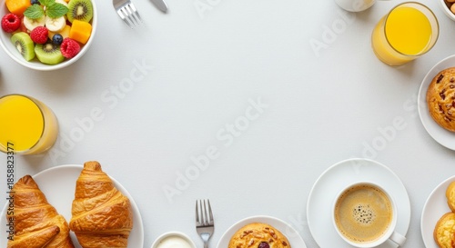 Breakfast spread with croissants, coffee, and fresh fruit for morning delight