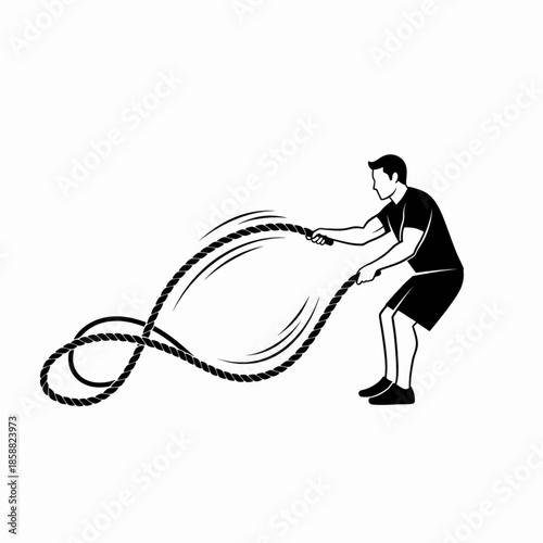 Athletic man using battle ropes during intense circuit training