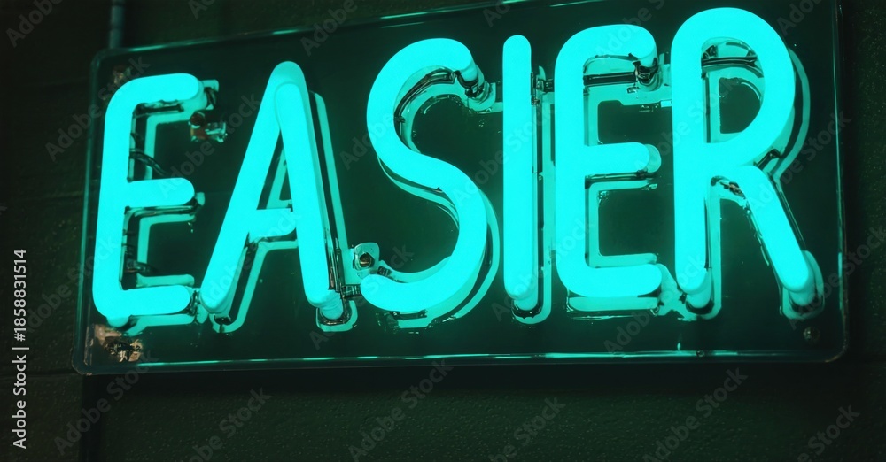 Obraz premium Bright neon sign displays word easier. Dark background emphasizes glowing turquoise lettering. Simple, direct message.