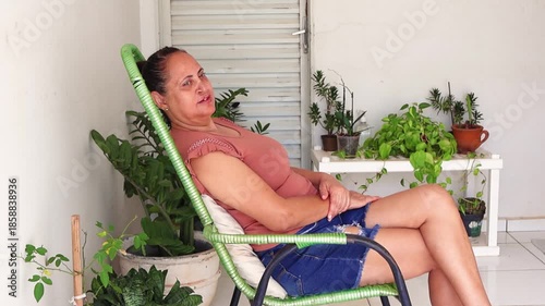Woman sitting on a patio chair relaxing outdoors