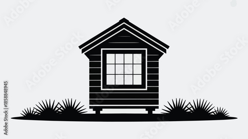 A small minimalistic house stands on stilts with spiky grass.