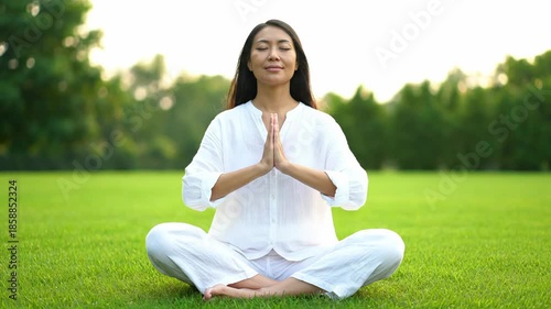 Woman Meditating in Serene Outdoor Setting.