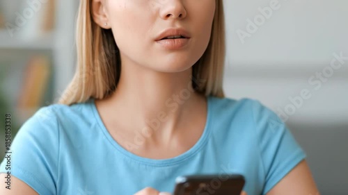 Close up of young woman using smartphone for communication indoors