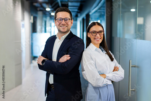 Konstfotografi Positive European business partners posing for portrait at office hallway interi
