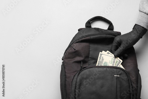 Thief's hand stealing money...