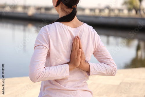 Young woman practicing yoga...