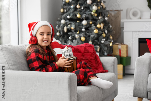 Cute little girl in headpho...