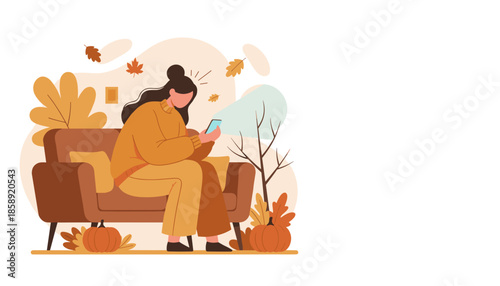 Cozy woman using a smartphone on a sofa surrounded by fall decorations and pumpkins