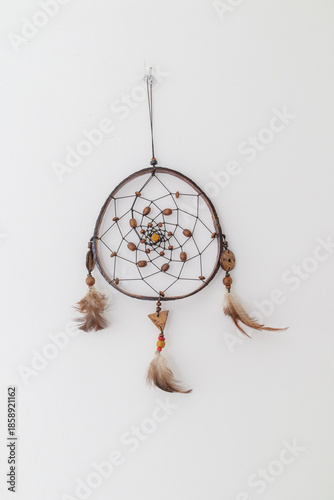 A dreamcatcher used as decoration on a white wall in Rio de Janeiro.