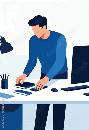 A person in a blue shirt arranging books and a phone on a desk