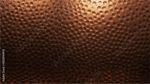 Close-up of a dark hammered copper surface with a textured dimpled pattern and metallic sheen.