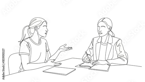 Two women are sitting at a table, engaged in a conversation, with one gesturing and the other taking notes.