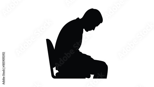 Silhouette of a discouraged or depressed man slumped over while sitting on an office chair illustrating feelings of failure fatigue or deep sadness