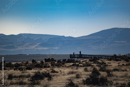 Hikers take in the view of the desert mountain range Owyhees.