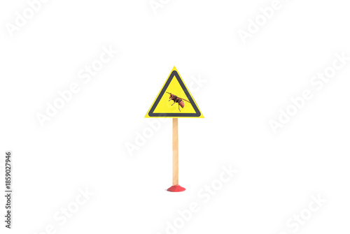 The warning sign is a silhouette of a hornet insect in a yellow triangle on a white background. The sign 