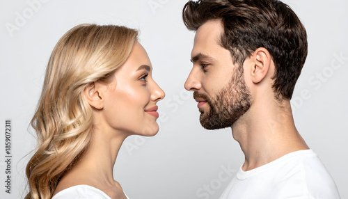 Couple looking at each other lovingly, minimal white studio setup, natural expressions