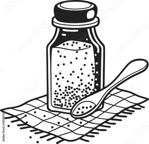 Salt in glass shaker with spoon on textured cloth, cooking seasoning ingredient for food preparation