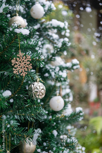 Close-up of Christmas tree decoration ornament, with fake snow soap bubbles, with blur bokeh background.