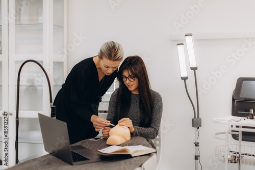 Beautician training student learning eyelash extension technique
