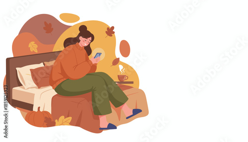 Woman relaxes in bed with phone and warm drink enjoying fall morning