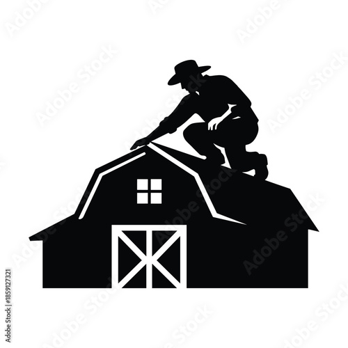 Silhouette of man working on barn roof