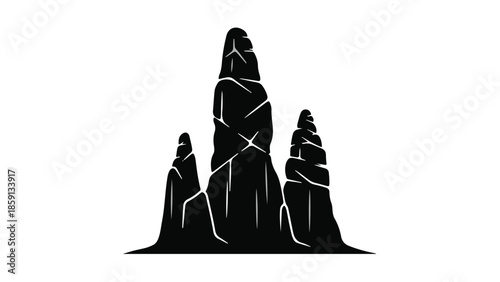 Dramatic silhouette of towering stalagmites in a dark cave