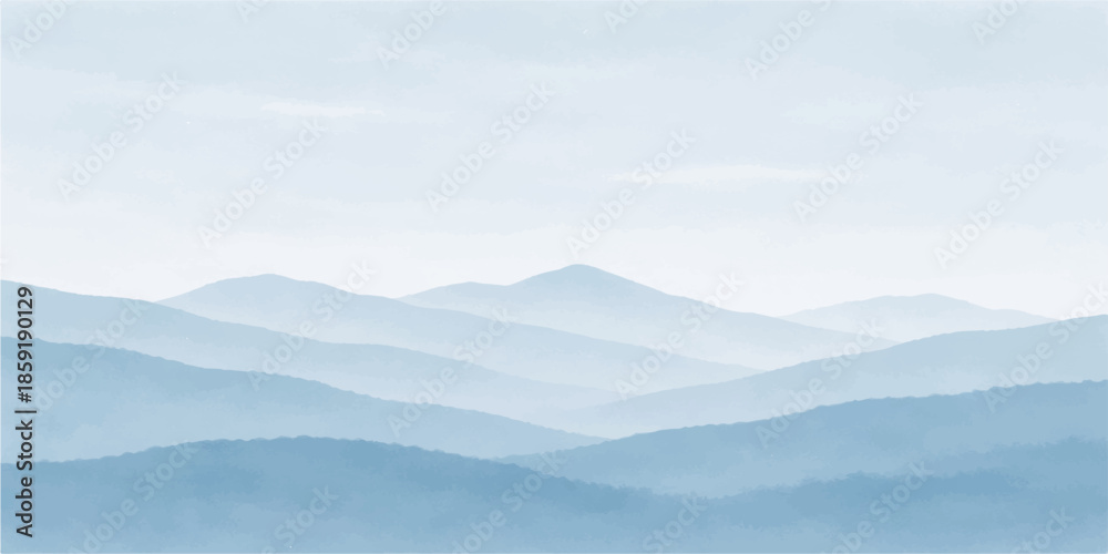 Obraz premium A misty mountain landscape at sunrise features a vast range of blue hills and snowy peaks under a glowing morning sky where fog and clouds drift over the forest valley