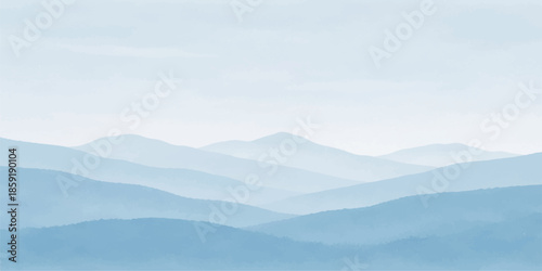 A misty mountain landscape unfolds at dawn as thick fog and clouds drift through a snow-capped forest valley under a soft blue sunrise sky