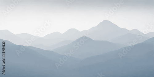 Misty mountain landscape featuring fog and clouds over a forest valley at sunset with a blue sky horizon