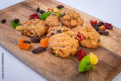 Cookies with freeze dried fruits and mint on wooden cutting board. Image selective focus photography