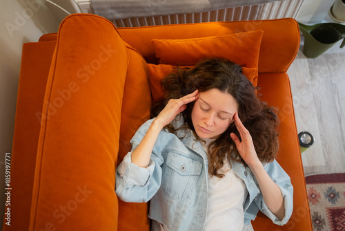 Картината върху платно Young woman suffering from a painful headache or migraine, feeling stressed, tir