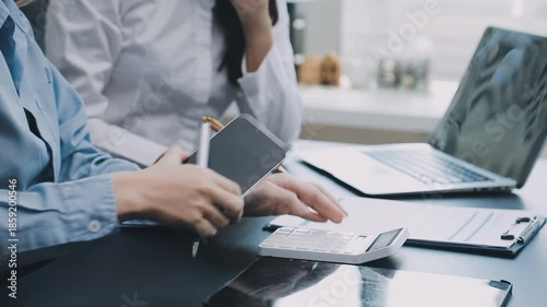 Human use calculator and calculate bills and paying bill, credit card, tax and vat, payment, concept of money management and business report with financial documents, financial accounting concept