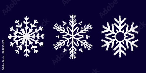Three intricately detailed white snowflakes against a dark navy background