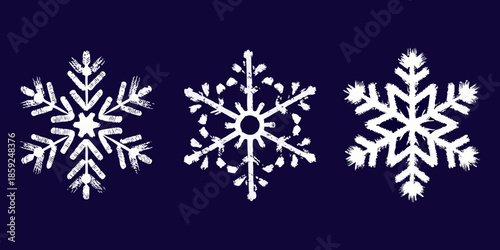 Three delicate white snowflakes on a dark blue background winter s artistry