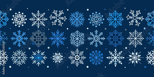 A seamless pattern of delicate blue and white snowflakes on a dark background