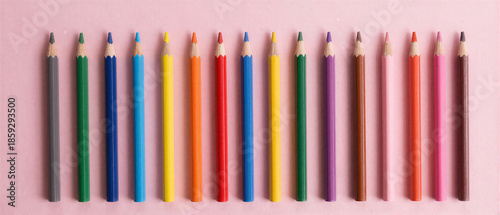 Colorful pencils row on pink background