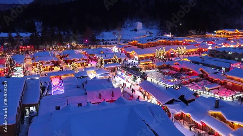 The view of Snow Town village in Harbin, China, during the winter festival with a snowstorm, with snow clinging to the rooftops of houses.