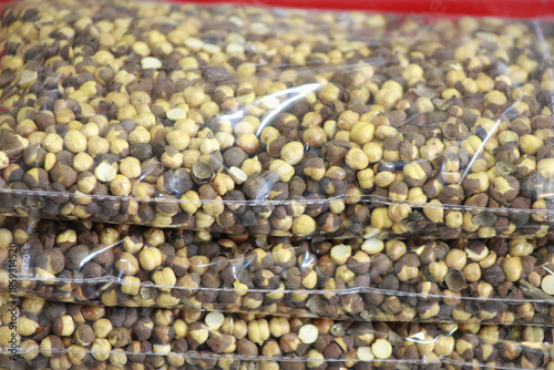 Stacked clear plastic bags of roasted chickpeas (bhuna chana), a popular healthy snack.
