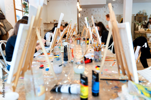 Women enjoying sip and paint class creating art