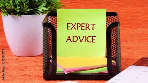 Animation of the appearance of the conceptual phrase EXPERT ADVICE on a sticker on a stand on an orange background. The concept of development, business, medicine