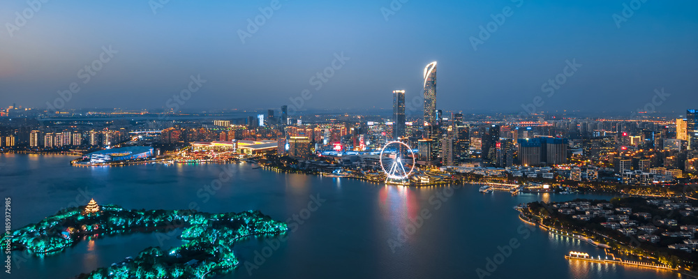 Fototapeta premium Aerial night view of Peach Blossom Island Ferris Wheel at Jinji Lake, Suzhou, Jiangsu, China