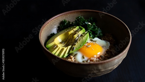 Healthy grain bowl with avocado fried egg kale and seeds in ceramic dish