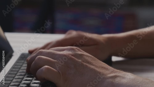 Close up of male hands alternating between resting and typing on a laptop keyboard. Natural posture, calm rhythm and focused everyday computer activity indoors. High quality 4k footage