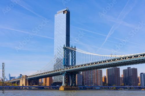 Manhattan Bridge spans the East River, connecting Brooklyn and Manhattan, with the city skyline.
