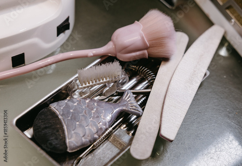 Tray with assorted manicure tools including brushes, files and clippers in beauty salon