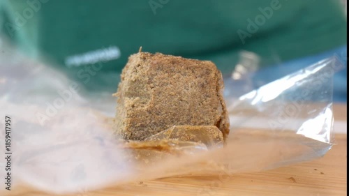 Hashish on a plastic bag fluttering in the wind, Macro shot, slow motion