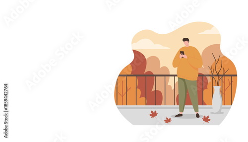 Relaxed man texting on a balcony during fall surrounded by orange leaves and nature